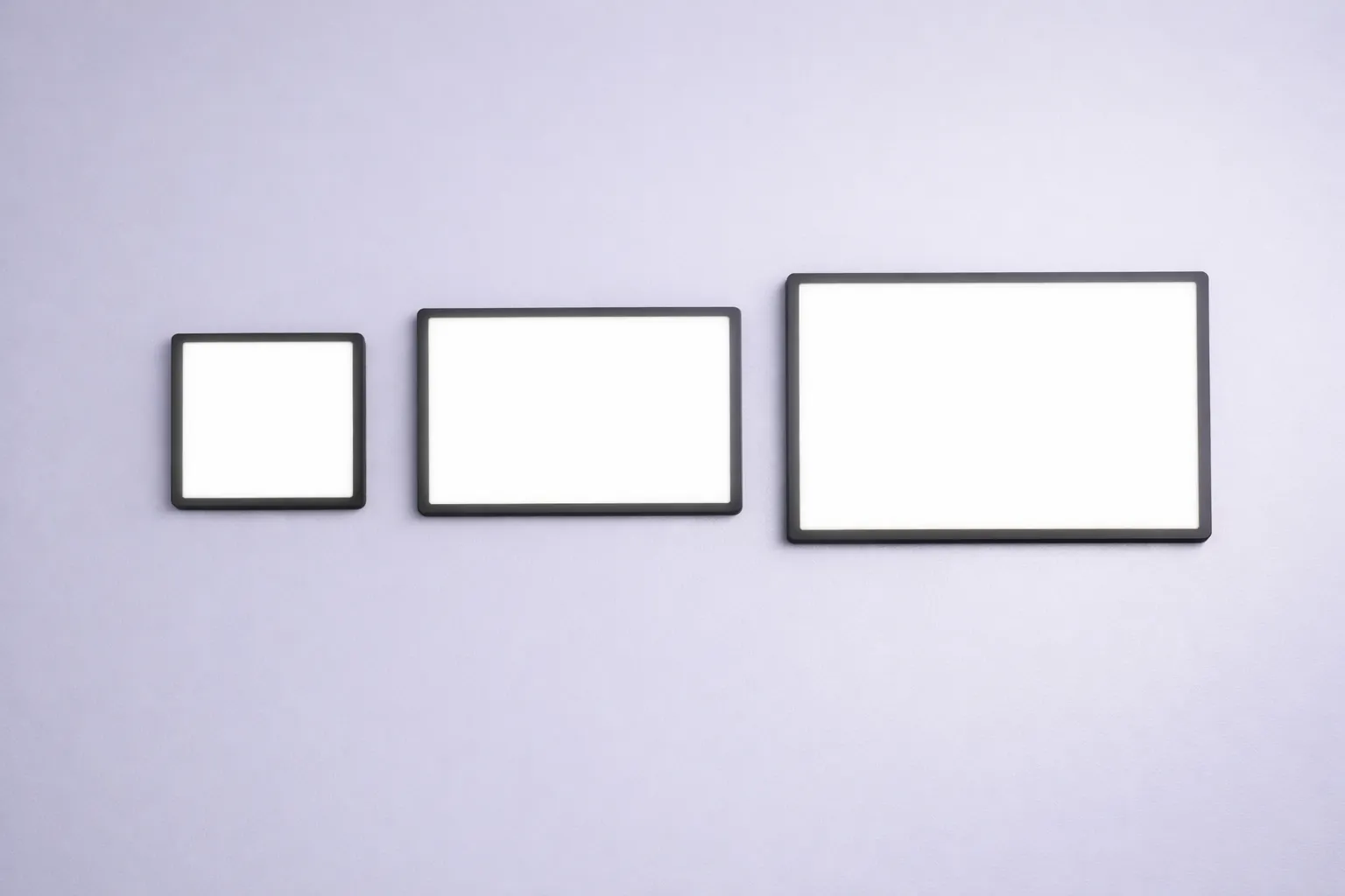 Three LED light pads of different sizes glowing side by side